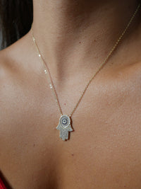Hamsa Necklace with diamond CZ cubic zirconia 14k gold plated hamsa necklace dainty sterling silver .925 waterproof. Unique hamsa necklaces. Fatima hand necklace for good luck. Statement hamsa necklace. unique everyday hamsa necklace for protection. evil eye necklace with cubic zirconia. Waterproof evil eye necklace with hamsa. Unique evil eye necklaces for everyday. shopping in Miami. Shopping in Brickell. Kesley Boutique